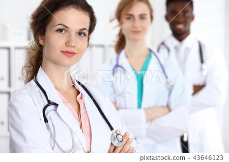 Happy doctor woman  with medical staff at the hospital 43646123