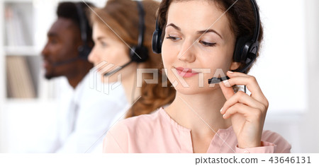 Call center operator.Young beautiful brunette woman in headset. Business concept Call center operator.Young beautiful brunette woman in headset. Business concept 43646131