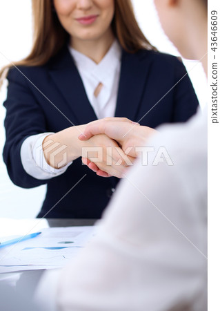 Group of business people shaking hands while finishing up a meeting. Handshaking, agreement or Group of business people shaking hands while finishing up a meeting. Handshaking, agreement or 43646609