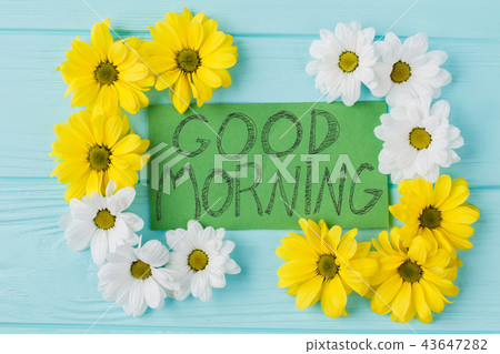 Good morning note and golden-daisy flowers composition. 43647282