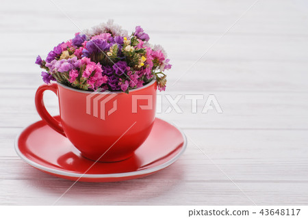 Limonium statice flowers bouquet in coffee mug. 43648117