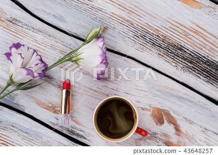 Lisianthus flowers, lipstick and cup of coffee. Lisianthus flowers, lipstick and cup of coffee. 43648257