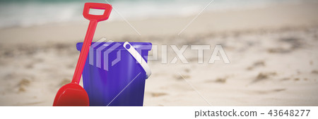 Composite image of blue bucket and red shovel 43648277