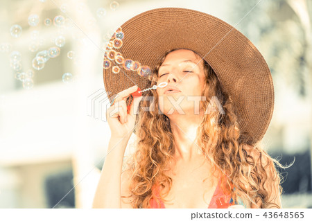 Happy young woman in swimsuit at swimming pool. Happy young woman in swimsuit at swimming pool. 43648565