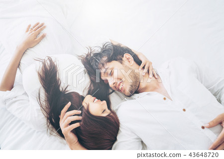 Happy young couple relaxing in the home bedroom. 43648720
