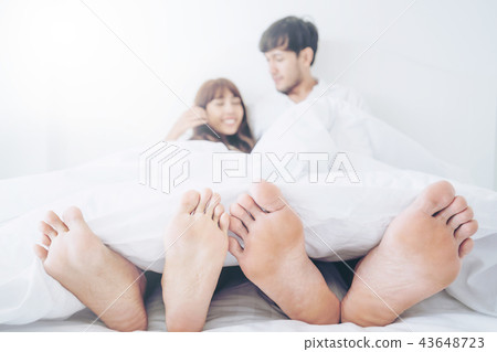 Happy young couple relaxing in the home bedroom. 43648723