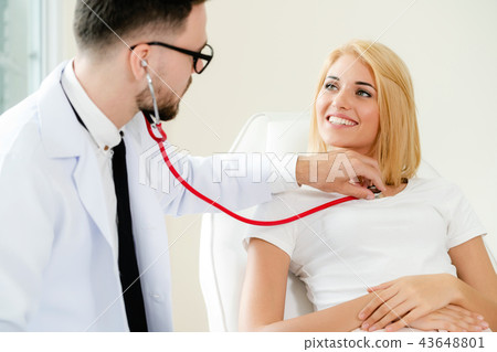 Male Doctor and Female Patient in Hospital Office 43648801