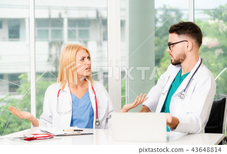 Two doctors partner works at office in hospital. Two doctors partner works at office in hospital. 43648814