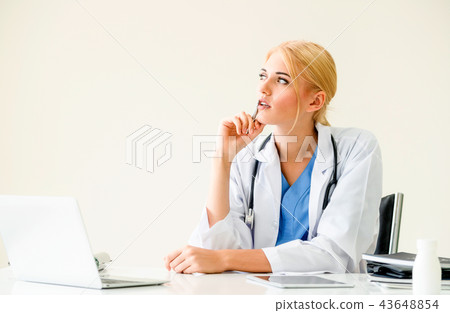 Doctor in hospital working on medical report. 43648854