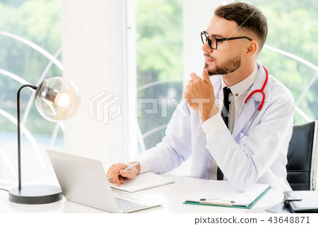 Doctor working with laptop computer at hospital. 43648871