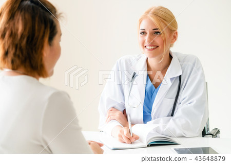 Woman Doctor and Female Patient in Hospital Office 43648879