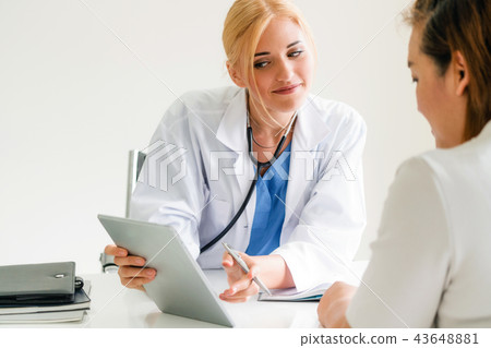 Woman Doctor and Female Patient in Hospital Office 43648881