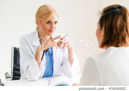Woman Doctor and Female Patient in Hospital Office 43648882