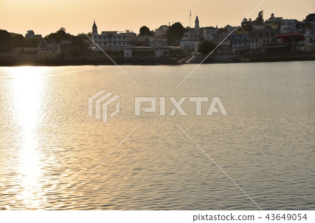 India Hindu holy land Pushkar cityscape Pushkar lake and bath ghat at twilight India Hindu holy land Pushkar cityscape Pushkar lake and bath ghat at twilight 43649054