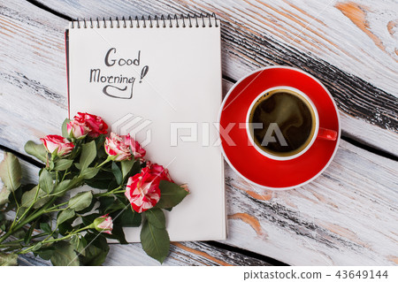 Cup of coffee, hybrid rose flowers and good morning note. 43649144