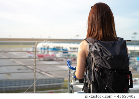 Woman standing at Airport Observation Deck Woman standing at Airport Observation Deck 43650402