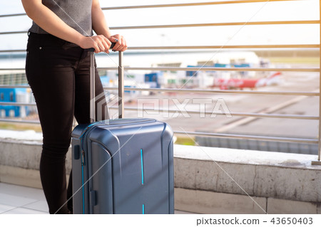 Young woman with suitcase in airtport Young woman with suitcase in airtport 43650403