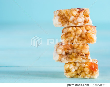 slices of muesli bar on blue background 43650968