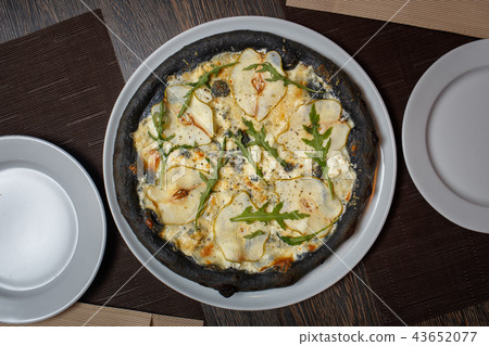 Black cheese pizza served on table in restaurant Black cheese pizza served on table in restaurant 43652077