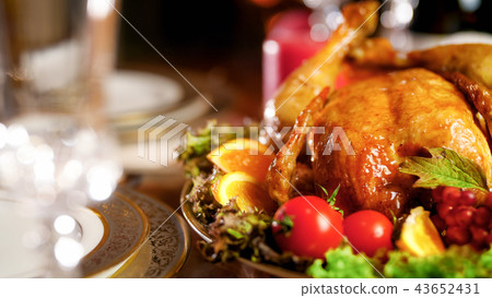 Closeup image of baked chicken with vegetables on served dinner table Closeup image of baked chicken with vegetables on served dinner table 43652431