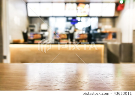 Table foreground with blurred fast food counter Table foreground with blurred fast food counter 43653011