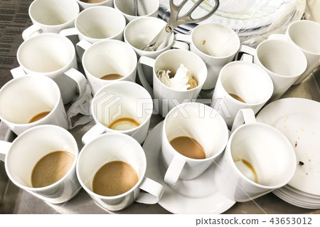 Pile of dirty used cups and plates for cleaning Pile of dirty used cups and plates for cleaning 43653012