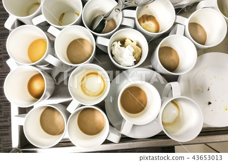 Pile of dirty used cups and plates for cleaning Pile of dirty used cups and plates for cleaning 43653013