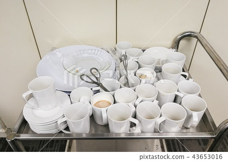 Pile of dirty used cups and plates for cleaning Pile of dirty used cups and plates for cleaning 43653016