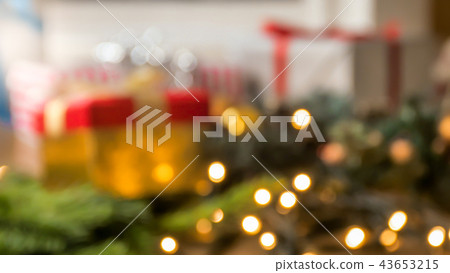 Beautiful Christmas out of focus background with glowing lights, garlands and gifts Beautiful Christmas out of focus background with glowing lights, garlands and gifts 43653215