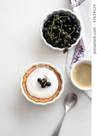 Delicious tart decorated with burned merengue and berries, served in white composition, with copy Delicious tart decorated with burned merengue and berries, served in white composition, with copy 43654124