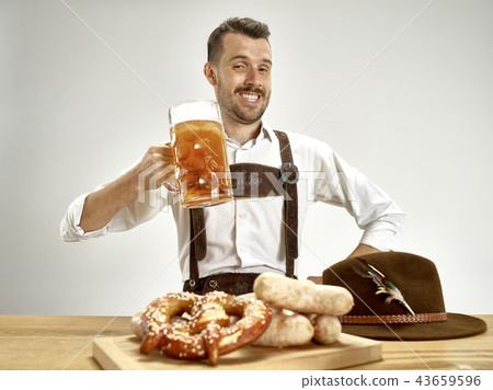 Germany, Bavaria, Upper Bavaria, man with beer dressed in traditional Austrian or Bavarian costume Germany, Bavaria, Upper Bavaria, man with beer dressed in traditional Austrian or Bavarian costume 43659596