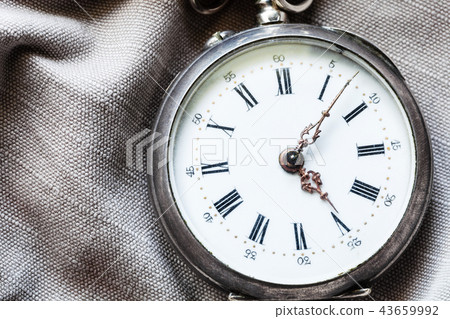 vintage pocket watch on gray textile background 43659992