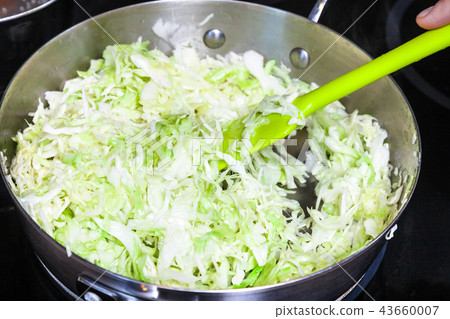 stewing fresh cabbage in frying pan stewing fresh cabbage in frying pan 43660007