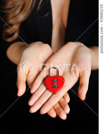 Beautiful girl with padlock heart-shape in hand 43660259