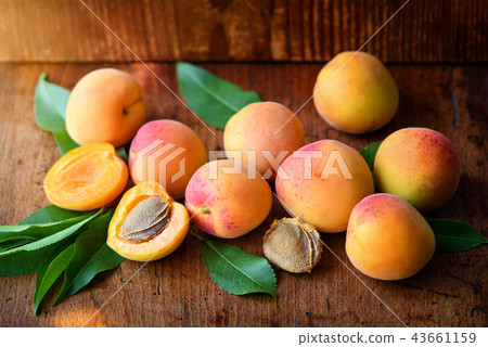 Ripe apricots on the old wooden background Ripe apricots on the old wooden background 43661159