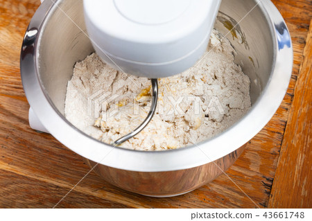 kitchen processor kneads dough with egg 43661748