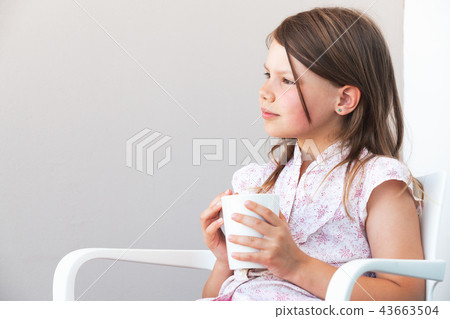 Portrait of blond little girl with white cup Portrait of blond little girl with white cup 43663504