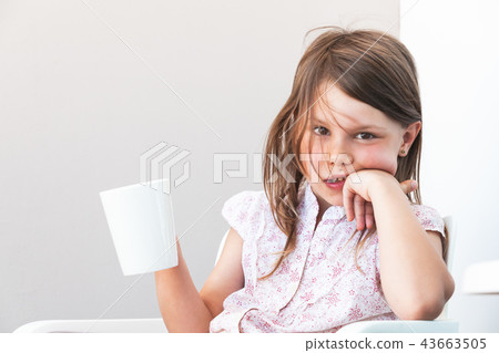 Portrait of little girl with cup of hot chocolate Portrait of little girl with cup of hot chocolate 43663505