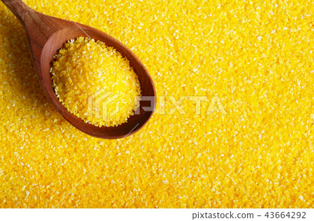 Corn grits yellow background with wooden spoon 43664292