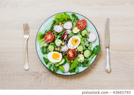 Fresh salad with vegetables for proper nutrition. Fresh salad with vegetables for proper nutrition. 43665793