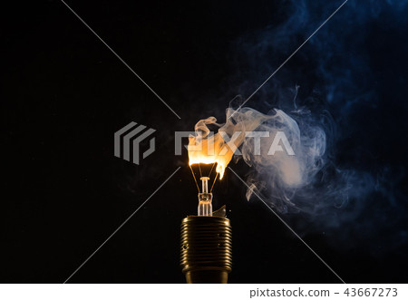 Burning old light bulb on black backround Burning old light bulb on black backround 43667273