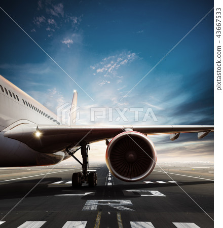 Commercial airplane on runway in day light. Commercial airplane on runway in day light. 43667533