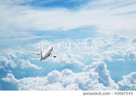 Commercial airplane flying above clouds 43667543