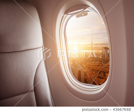 Airplane interior with window view of Dubai city 43667698