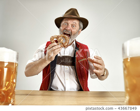 Germany, Bavaria, Upper Bavaria, man with beer dressed in traditional Austrian or Bavarian costume 43667849