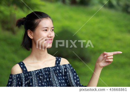 Young woman signal green background 43668861