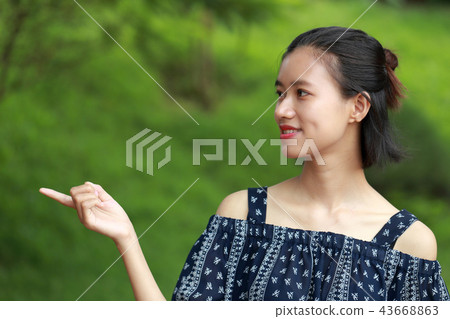 Young woman signal green background Young woman signal green background 43668863