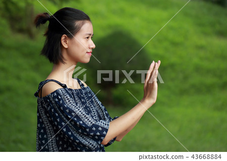 Young woman signal green background Young woman signal green background 43668884