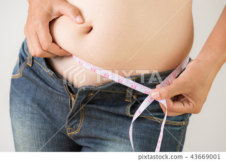 Fat woman hand measuring waist 43669001