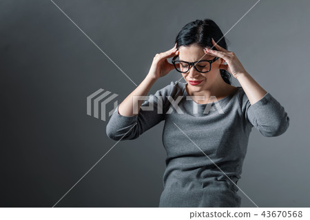 Young woman suffering from head ache 43670568